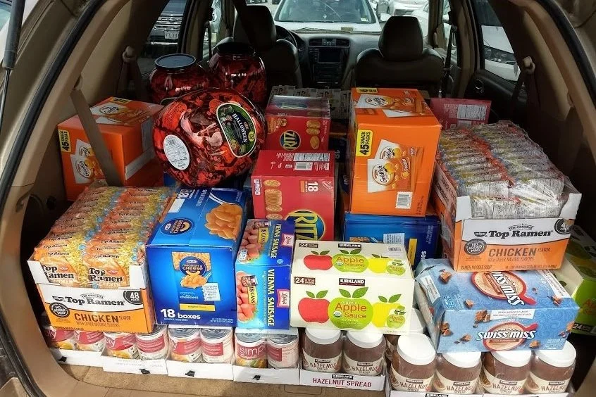 A car trunk packed with donated food for the school food program