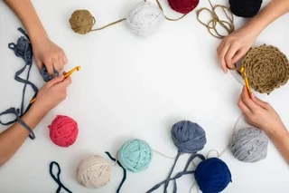 Hands crocheting with yarn